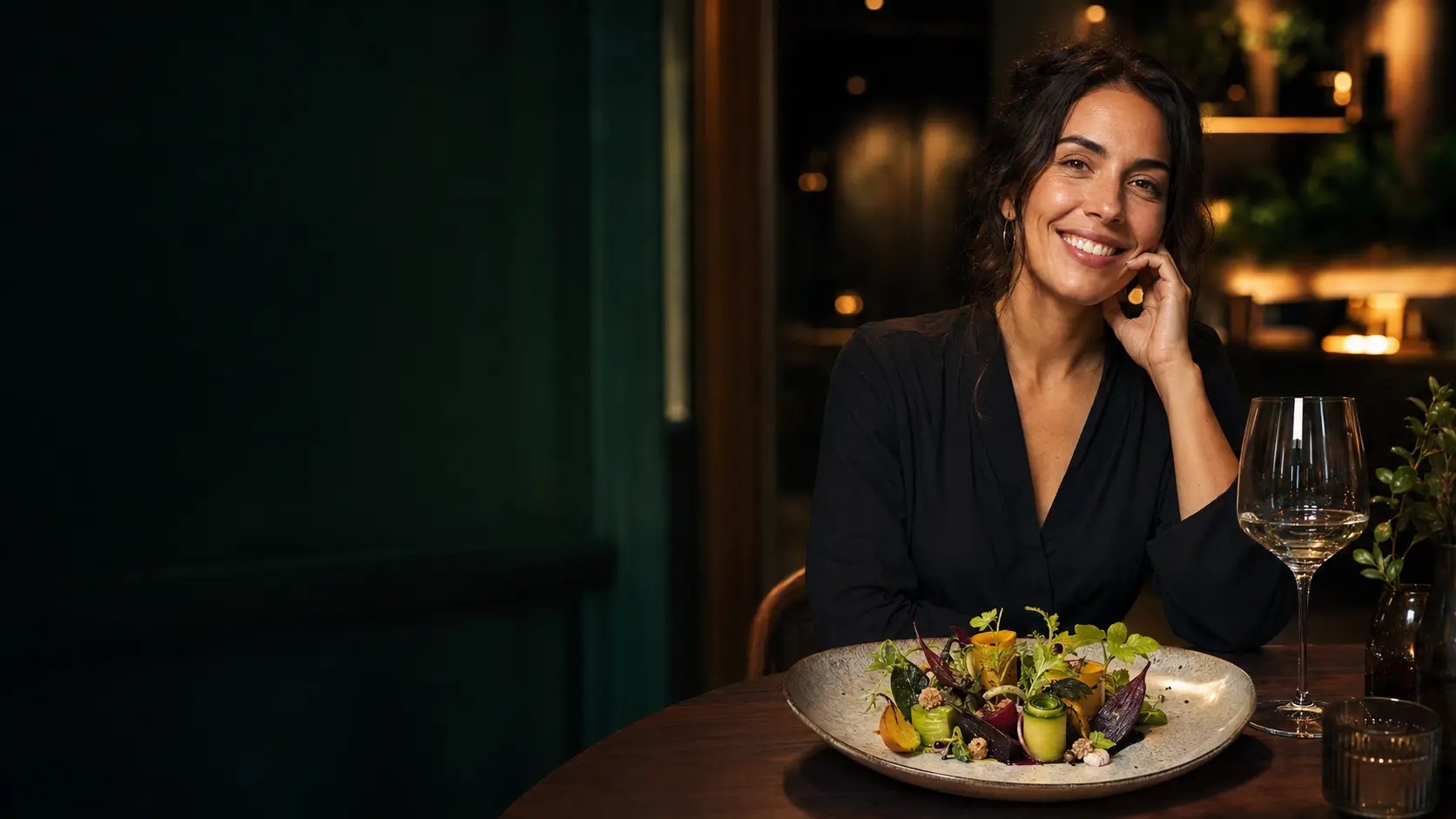 A smiling diner enjoying an elegant plant-based meal